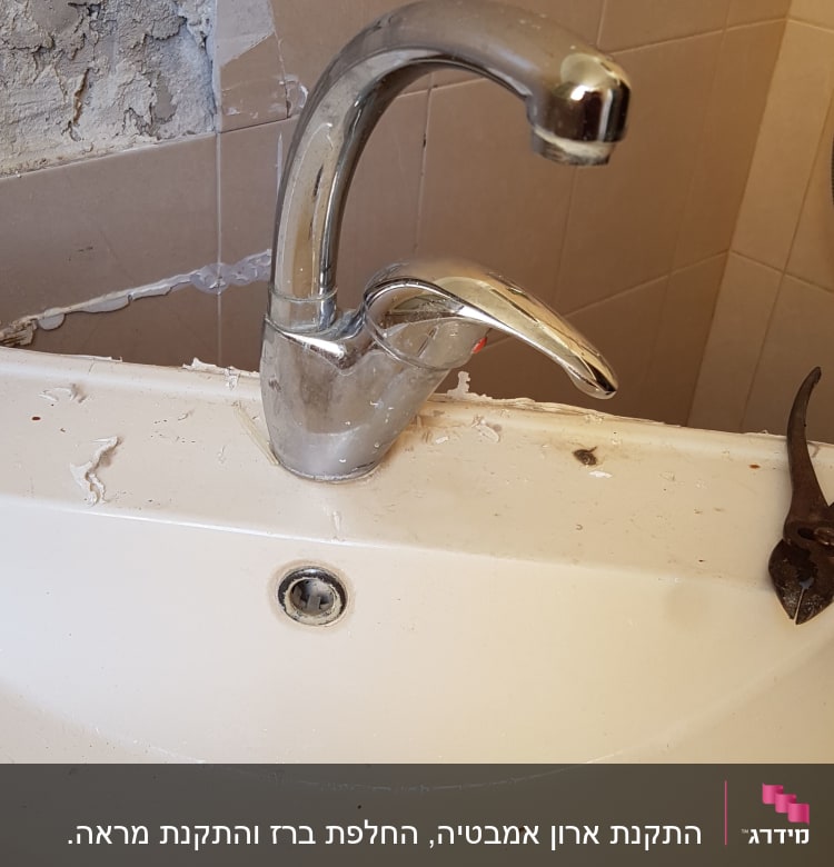 ברז כיור עם סימני תיקון וכלי עבודה